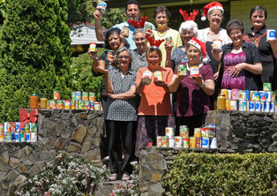 volunteers with donated tins of food